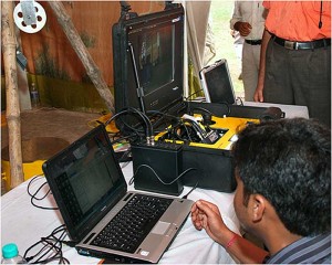 The VideoRay control unit with the portable LYYN T38™ video enhancer standing between the laptop and the console.